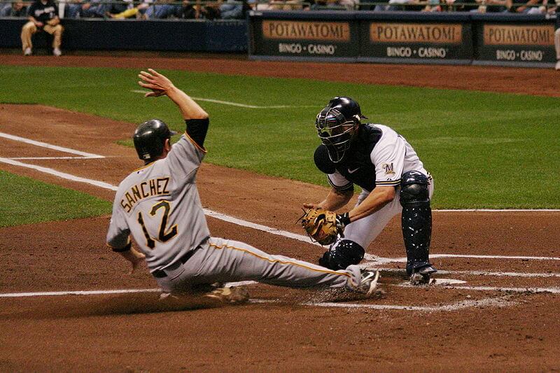 baseball player sliding into home